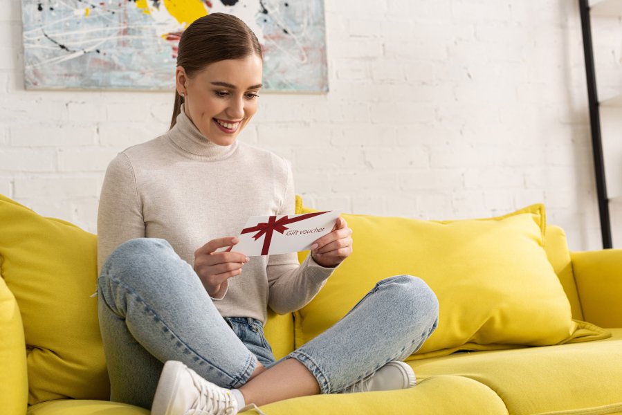 Woman smiling as she opens a gift